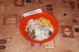 Шаг 4. Вбить в миску с фаршем яйца, добавить кефир, измельченный чеснок и специи