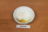 Шаг 1. В глубокой миске смешать яйцо, творог, йогурт и муку.