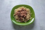 Шаг 6. В тарелки порционно выложить спагетти и сверху соус с фаршем.