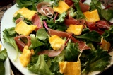 Шаг 3. На тарелку выложить салатные листья, порезанный омлет, хамон.