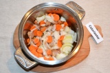 Шаг 4. К обжаренному мясу добавить лук и морковь.