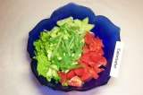 Шаг 5. Смешать салат, огурцы, помидоры и зелёный лук, добавить листья рукколы.