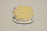Шаг 5. Твердый сыр натереть на крупной терке, смазать оставшимся йогуртом.